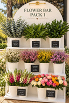Flower Bar Pack 1 DIY flower bar display with eucalyptus, leather leaf, ruscus, limonium, snapdragon and spray roses in white buckets